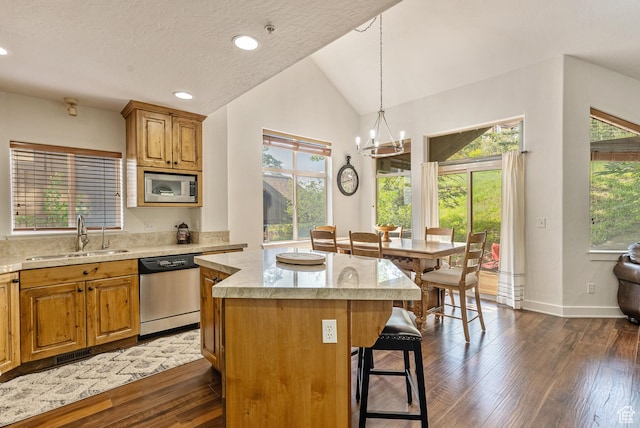 5150 Cove Canyon Dr Unit A, Park City, UT 84098 - kitchen featuring appliances with stainless steel finishes, a breakfast bar, lofted ceiling, a kitchen island, and a chandelier