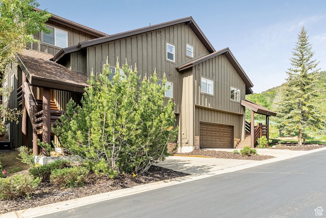 5150 Cove Canyon Dr Unit A, Park City, UT 84098 - view of front of property with board and batten siding, stairway, an attached garage, and driveway
