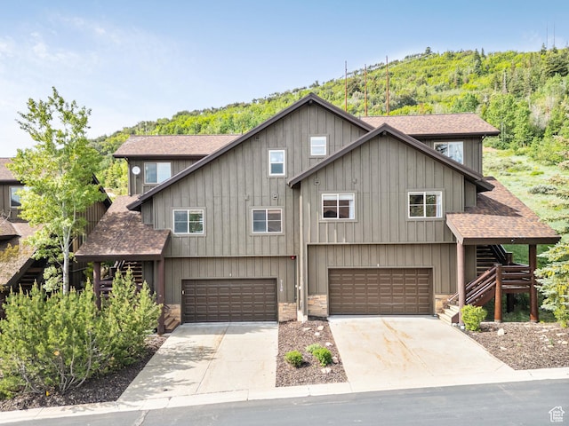5150 Cove Canyon Dr Unit A, Park City, UT 84098 - view of front facade with a shingled roof, a garage, stairway, and driveway