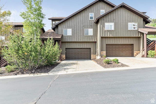 5150 Cove Canyon Dr Unit A, Park City, UT 84098 - view of front of property featuring stone siding, roof with shingles, a garage, and driveway