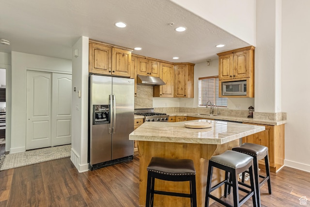 5150 Cove Canyon Dr Unit A, Park City, UT 84098 - kitchen with stainless steel appliances, under cabinet range hood, light countertops, dark wood finished floors, and recessed lighting