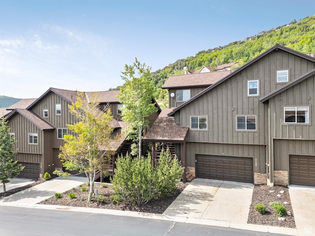 5150 Cove Canyon Dr Unit A, Park City, UT 84098 - view of front facade featuring roof with shingles, a garage, driveway, and stone siding