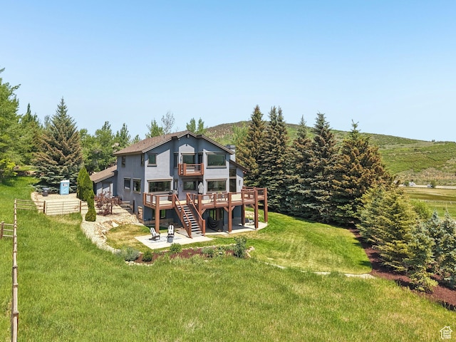 2570 Aspen Springs Dr, Park City, UT 84060 - rear view of property with a patio area, a wooden deck, a lawn, stairs, and stucco siding