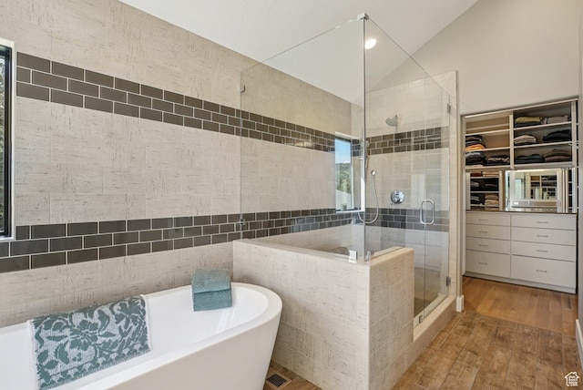 2570 Aspen Springs Dr, Park City, UT 84060 - full bathroom with a shower stall, wood finished floors, a freestanding tub, a walk in closet, and lofted ceiling