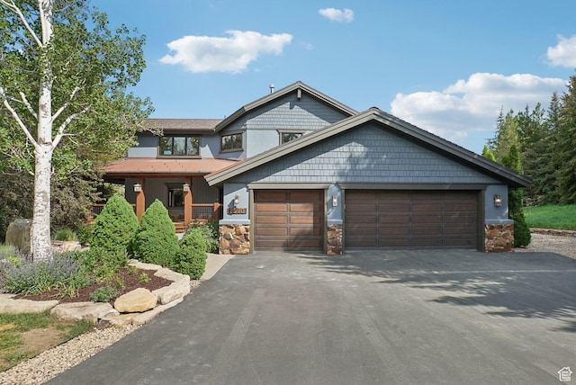 2570 Aspen Springs Dr, Park City, UT 84060 - view of front of home with asphalt driveway, stone siding, and an attached garage