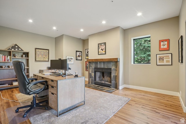 2570 Aspen Springs Dr, Park City, UT 84060 - office with wood finished floors, a tiled fireplace, and recessed lighting