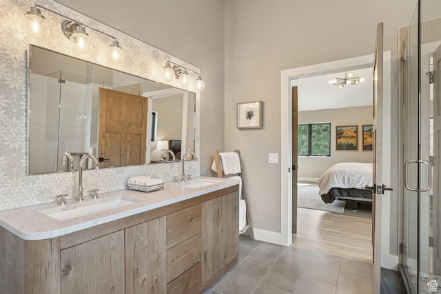 2570 Aspen Springs Dr, Park City, UT 84060 - ensuite bathroom featuring double vanity, tile patterned flooring, a shower stall, a chandelier, and tasteful backsplash