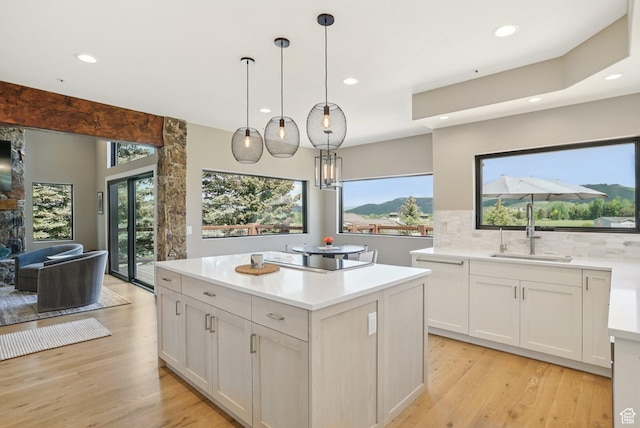 2570 Aspen Springs Dr, Park City, UT 84060 - kitchen featuring black electric stovetop, light wood-style flooring, decorative backsplash, recessed lighting, and healthy amount of natural light