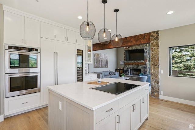 2570 Aspen Springs Dr, Park City, UT 84060 - kitchen with stainless steel double oven, black electric cooktop, white cabinetry, and recessed lighting