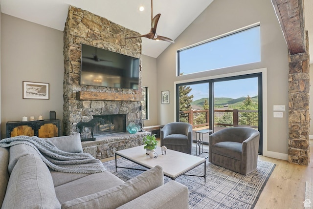 2570 Aspen Springs Dr, Park City, UT 84060 - living area with high vaulted ceiling, ceiling fan, a fireplace, and wood finished floors