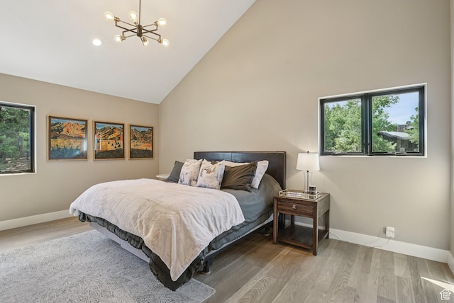 2570 Aspen Springs Dr, Park City, UT 84060 - bedroom with high vaulted ceiling, multiple windows, a chandelier, and wood finished floors