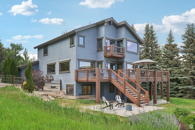 2570 Aspen Springs Dr, Park City, UT 84060 - rear view of property with stucco siding, stairway, a patio, and a balcony