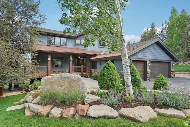 2570 Aspen Springs Dr, Park City, UT 84060 - view of front of property with covered porch, concrete driveway, an attached garage, and stone siding