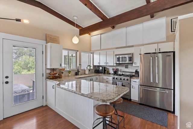 4560 S Wallace Ln, Holladay, UT 84117 - kitchen with appliances with stainless steel finishes, a peninsula, backsplash, white cabinets, and beam ceiling