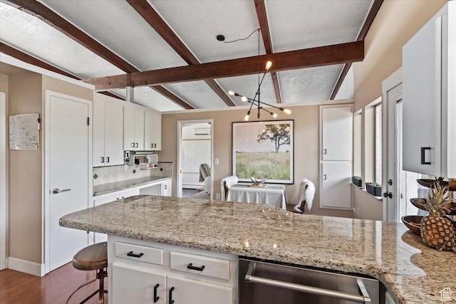 4560 S Wallace Ln, Holladay, UT 84117 - kitchen with stainless steel dishwasher, white cabinetry, dark wood-style floors, tasteful backsplash, and a chandelier