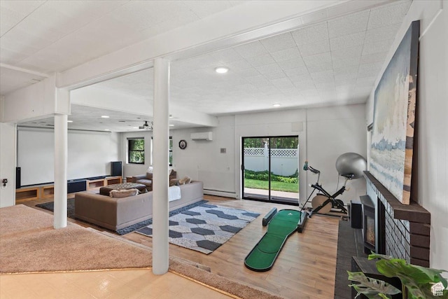 4560 S Wallace Ln, Holladay, UT 84117 - exercise room featuring a wall unit AC, a baseboard heating unit, wood finished floors, a fireplace, and recessed lighting