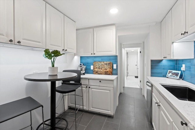 4560 S Wallace Ln, Holladay, UT 84117 - kitchen featuring white cabinets, tasteful backsplash, dark tile patterned floors, recessed lighting, and stainless steel dishwasher