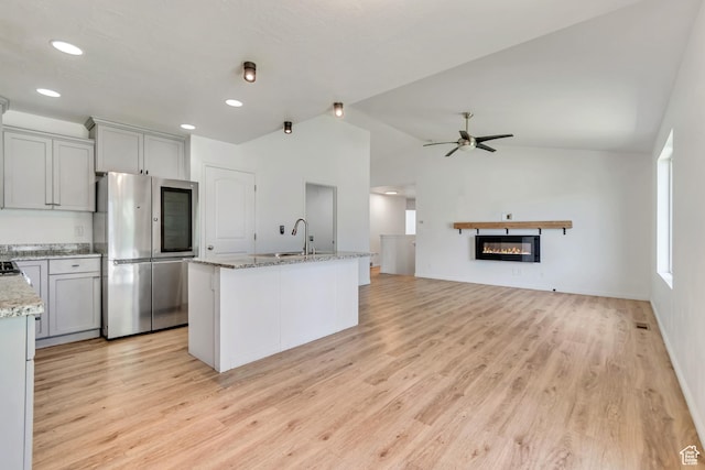 327 E 2260 S, Heber City, UT 84032 - kitchen with smart refrigerator, light wood-type flooring, lofted ceiling, a ceiling fan, and light stone counters