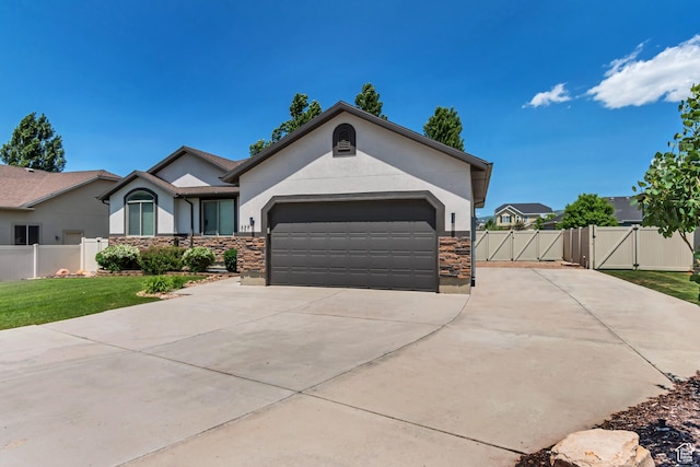 327 E 2260 S, Heber City, UT 84032 - ranch-style house featuring a gate, stucco siding, stone siding, concrete driveway, and an attached garage