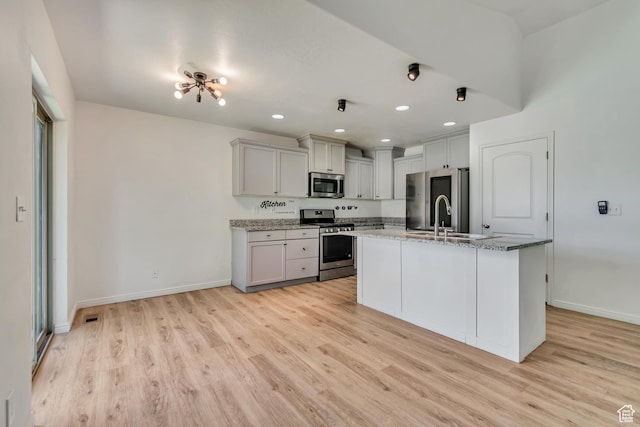 327 E 2260 S, Heber City, UT 84032 - kitchen featuring stainless steel appliances, light wood-style flooring, light stone counters, an island with sink, and recessed lighting