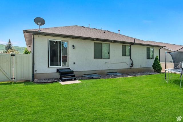327 E 2260 S, Heber City, UT 84032 - rear view of house with a trampoline, roof with shingles, a gate, and entry steps