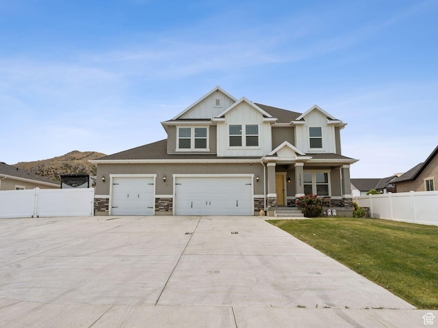 13698 S Black Hoof Cir, Herriman, UT 84096 - craftsman-style home with stone siding, driveway, an attached garage, and board and batten siding
