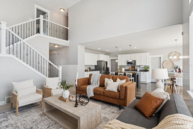 13698 S Black Hoof Cir, Herriman, UT 84096 - living room with stairs, a high ceiling, a chandelier, and recessed lighting