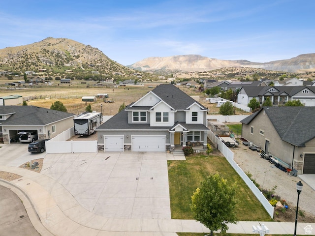 13698 S Black Hoof Cir, Herriman, UT 84096 - view of front of home featuring driveway, a mountain view, a residential view, stone siding, and an attached garage