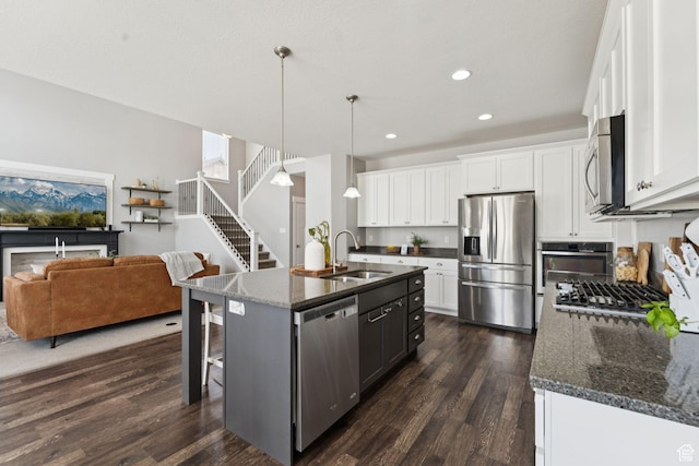 13698 S Black Hoof Cir, Herriman, UT 84096 - kitchen with stainless steel appliances, dark wood-style floors, recessed lighting, a breakfast bar, and dark stone countertops