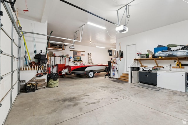 13698 S Black Hoof Cir, Herriman, UT 84096 - garage featuring a workshop area, a garage door opener, and freestanding refrigerator