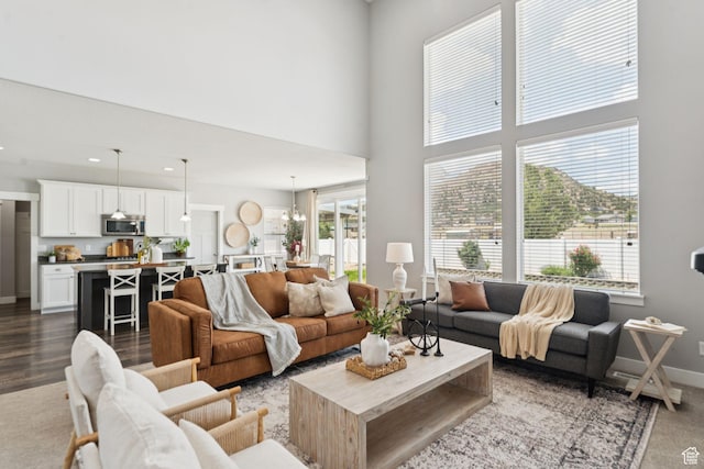13698 S Black Hoof Cir, Herriman, UT 84096 - living room featuring a high ceiling, recessed lighting, a chandelier, and dark wood-style flooring
