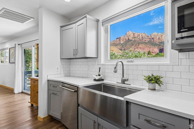 34 Valley View Dr, Springdale, UT 84767 - kitchen with gray cabinets, appliances with stainless steel finishes, dark wood-style flooring, and decorative backsplash