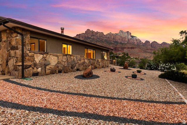 34 Valley View Dr, Springdale, UT 84767 - back of house at dusk with stone siding and stucco siding