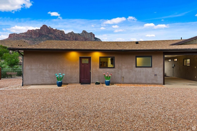 34 Valley View Dr, Springdale, UT 84767 - view of front of property featuring stucco siding, a mountain view, and a shingled roof