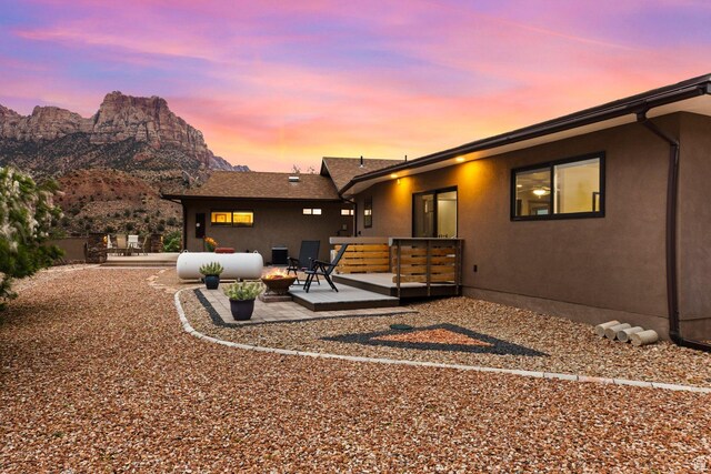 34 Valley View Dr, Springdale, UT 84767 - back of house with a deck with mountain view, a patio area, and stucco siding