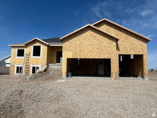 3191 S 5100 W Unit 1, Hooper, UT 84315 - view of front of house featuring a garage, stucco siding, and gravel driveway