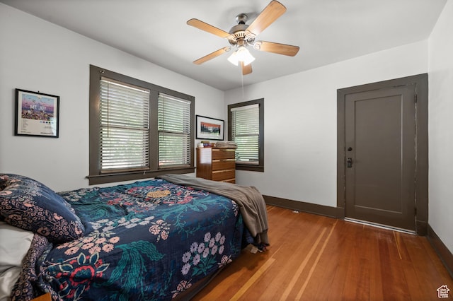 832 E Ramona Ave, Salt Lake City, UT 84105 - bedroom with multiple windows, wood finished floors, and a ceiling fan