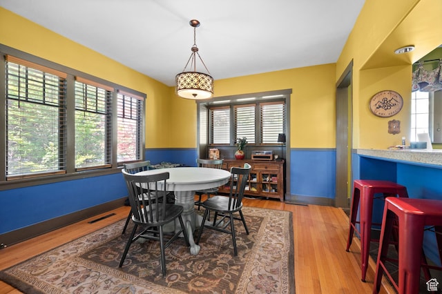 832 E Ramona Ave, Salt Lake City, UT 84105 - dining space with plenty of natural light, wainscoting, and wood finished floors