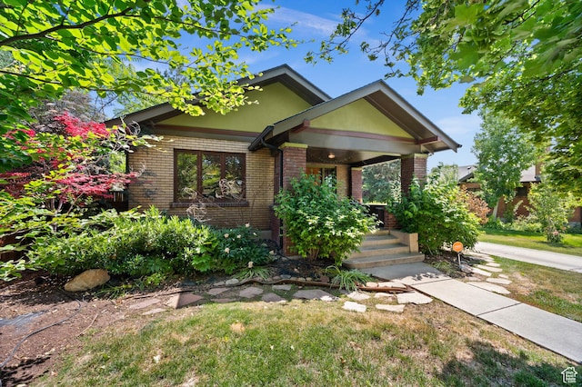 832 E Ramona Ave, Salt Lake City, UT 84105 - view of front facade with brick siding, covered porch, and a front yard