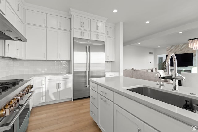 4473 N Solstice Dr, Lehi, UT 84043 - kitchen with high end appliances, under cabinet range hood, light countertops, open floor plan, and recessed lighting