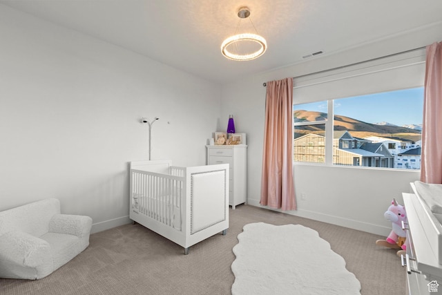 4473 N Solstice Dr, Lehi, UT 84043 - bedroom featuring light carpet, a nursery area, and a chandelier