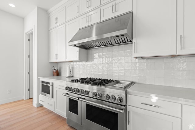 4473 N Solstice Dr, Lehi, UT 84043 - kitchen featuring under cabinet range hood, range with two ovens, light countertops, light wood-type flooring, and recessed lighting