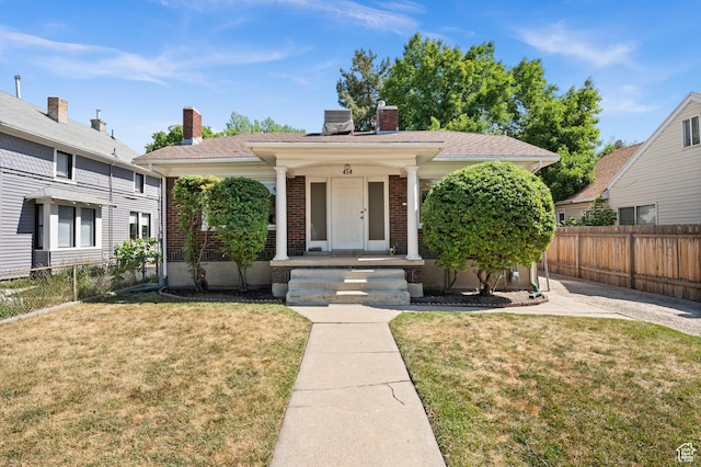 454 E Bryan Ave, Salt Lake City, UT 84115 - view of front facade with a porch, a chimney, and brick siding