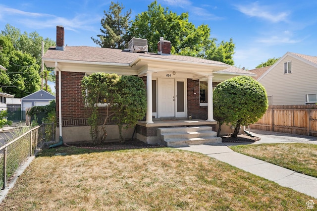 454 E Bryan Ave, Salt Lake City, UT 84115 - view of front of home with a chimney, brick siding, and a porch