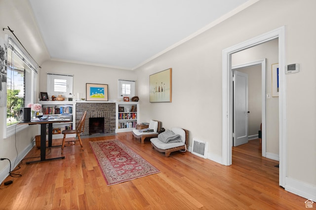 454 E Bryan Ave, Salt Lake City, UT 84115 - sitting room with wood finished floors, a fireplace, and ornamental molding