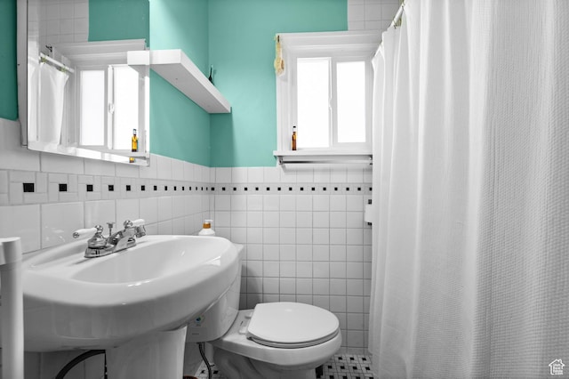 454 E Bryan Ave, Salt Lake City, UT 84115 - bathroom featuring tile walls, a wainscoted wall, and curtained shower