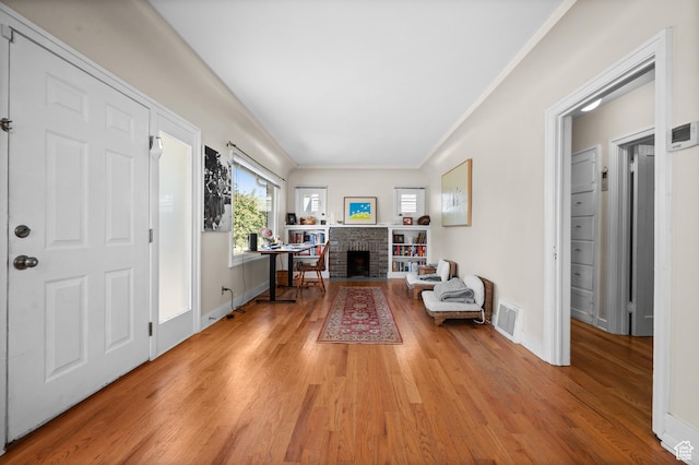 454 E Bryan Ave, Salt Lake City, UT 84115 - entryway with light wood-style floors, crown molding, and a fireplace