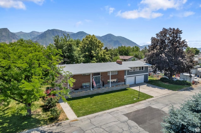 1775 S 290 E, Orem, UT 84058 - view of front of property featuring a garage, driveway, a front lawn, a mountain view, and brick siding