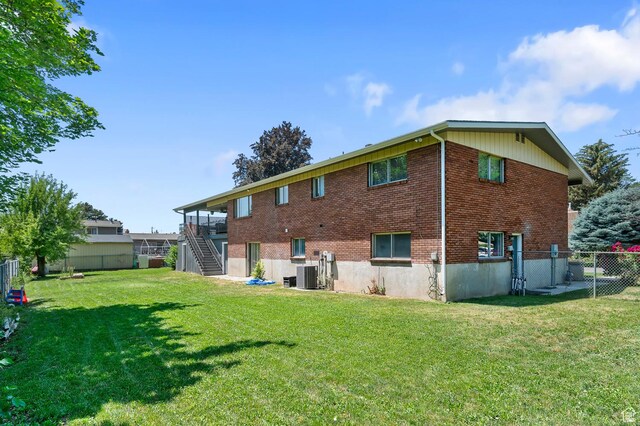 1775 S 290 E, Orem, UT 84058 - back of property featuring stairs, a fenced backyard, and brick siding