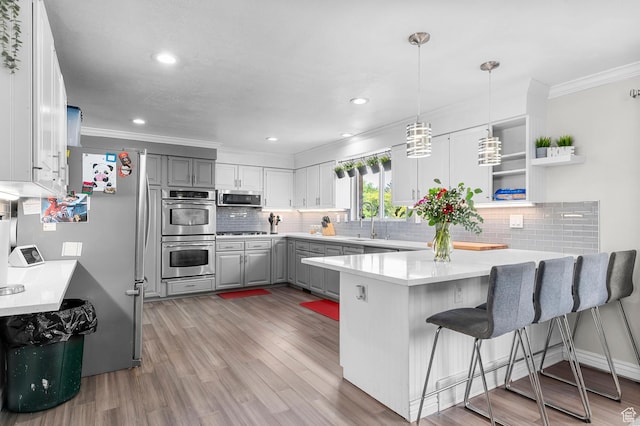 1775 S 290 E, Orem, UT 84058 - kitchen with stainless steel appliances, gray cabinetry, a peninsula, ornamental molding, and backsplash